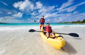 26126028 - father and son kayaking at tropical ocean