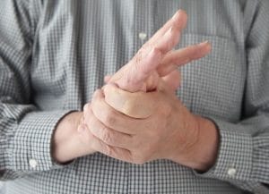 18172074 - a man tries to restore feeling in his hand by squeezing