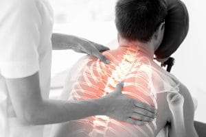 Digital composite of Highlighted spine of man at physiotherapy